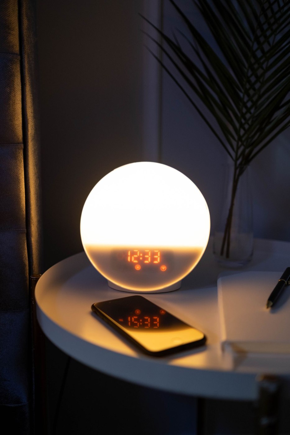 Alarm Clock and Phone on a Side Table