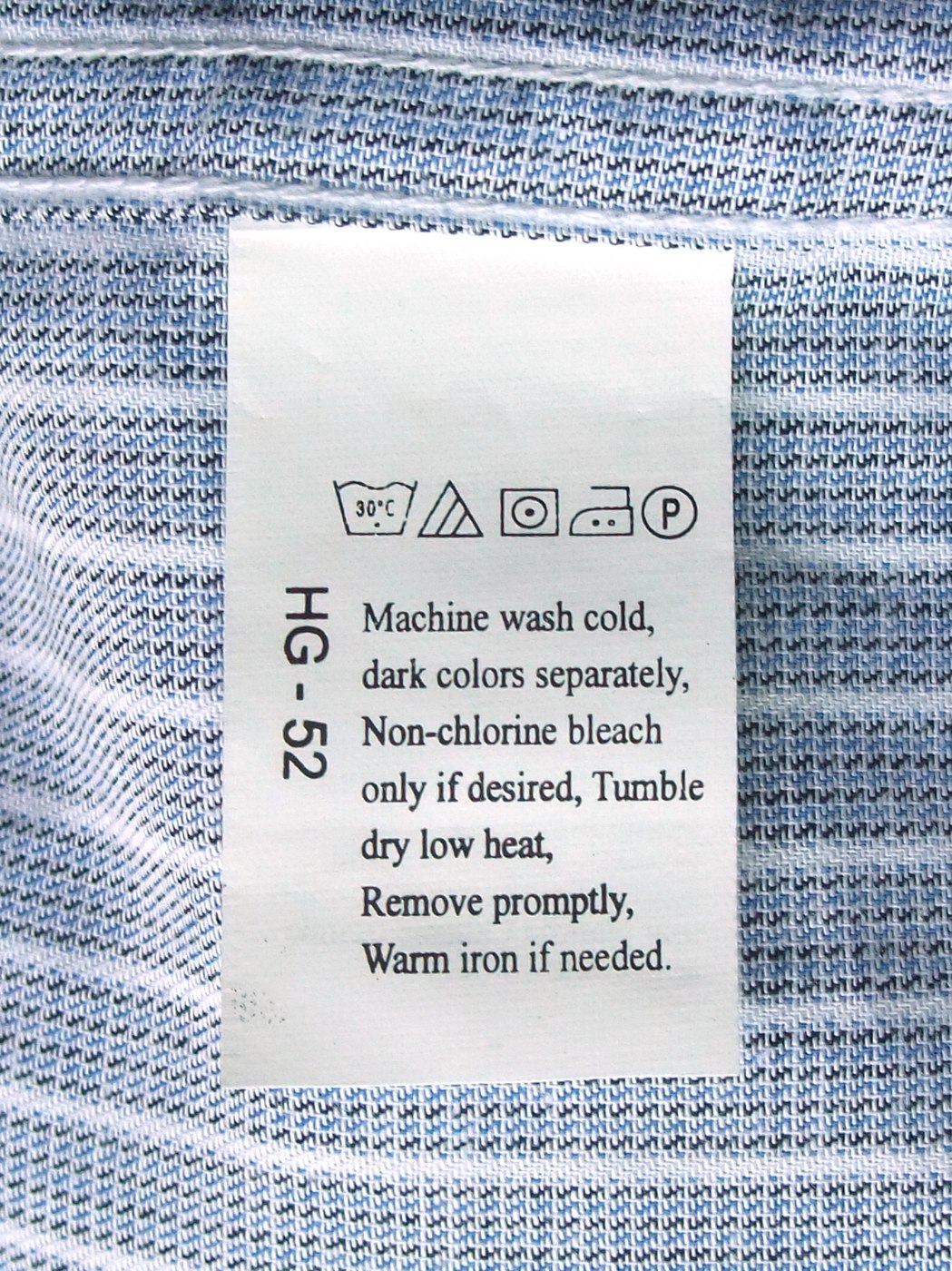 Laundry care symbols printed on a shirt label