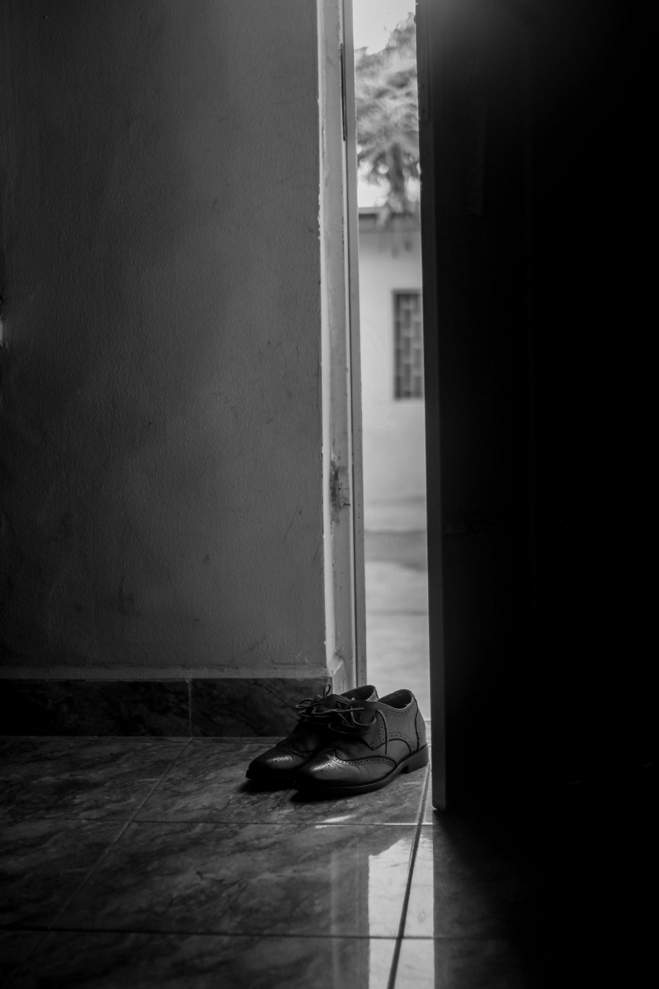 Black and White Photography of Elegant Shoes in the Entrance