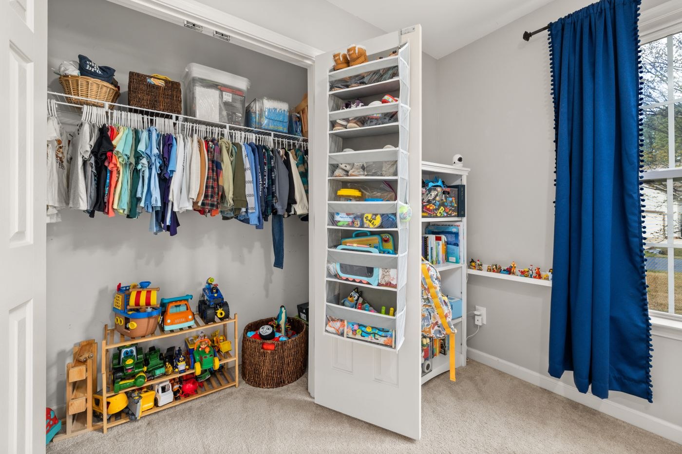 Organized Children's Closet with Toys and Clothes