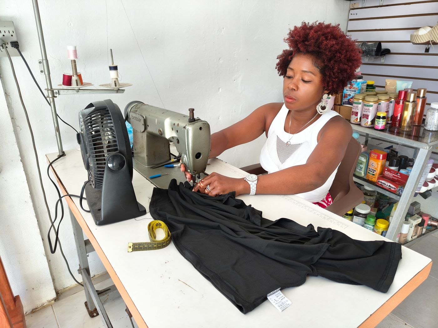 Woman Sewing Clothes on a Mechanical Machine in Workshop