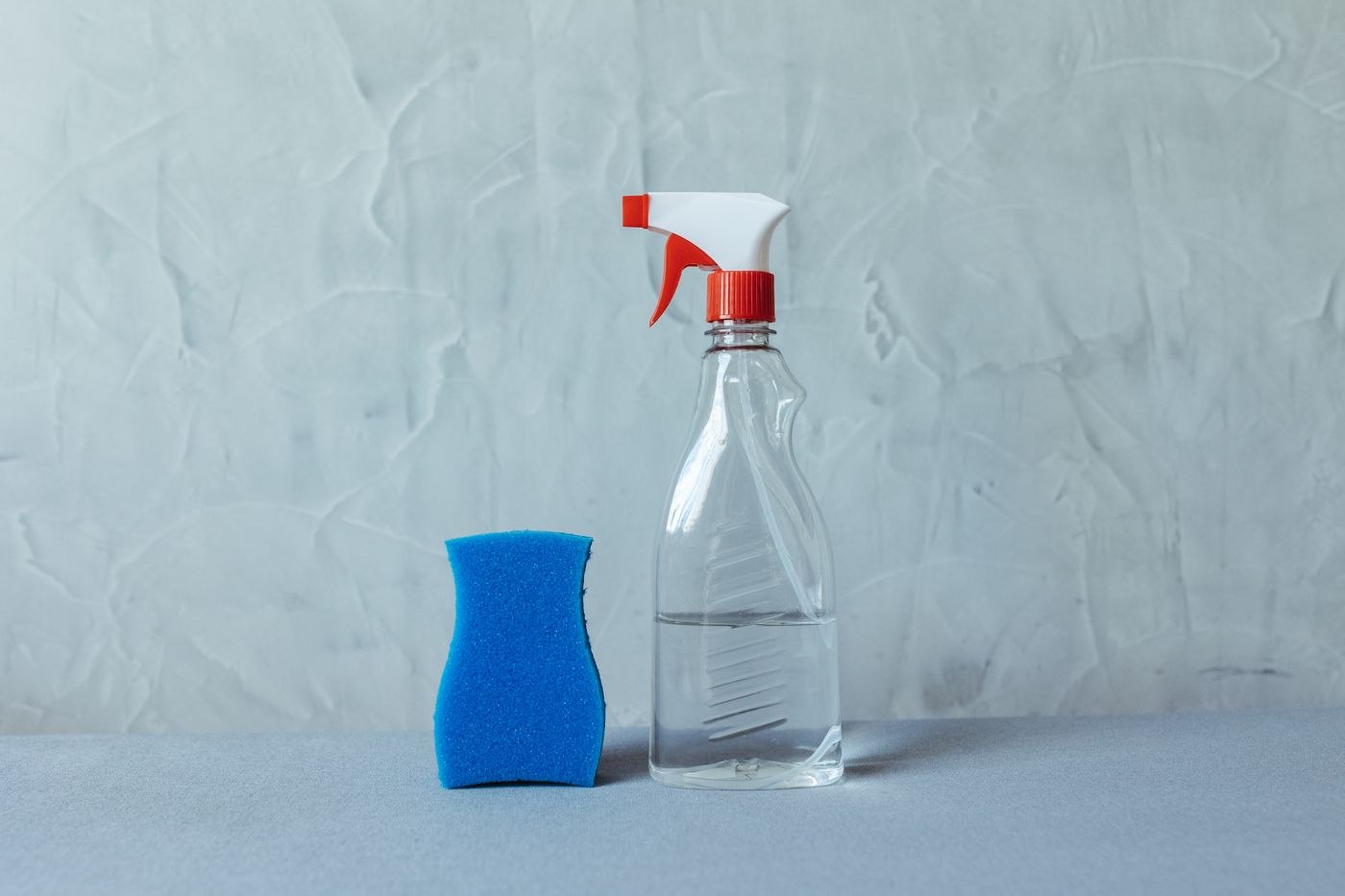 Minimalist Cleaning Supplies on Grey Background