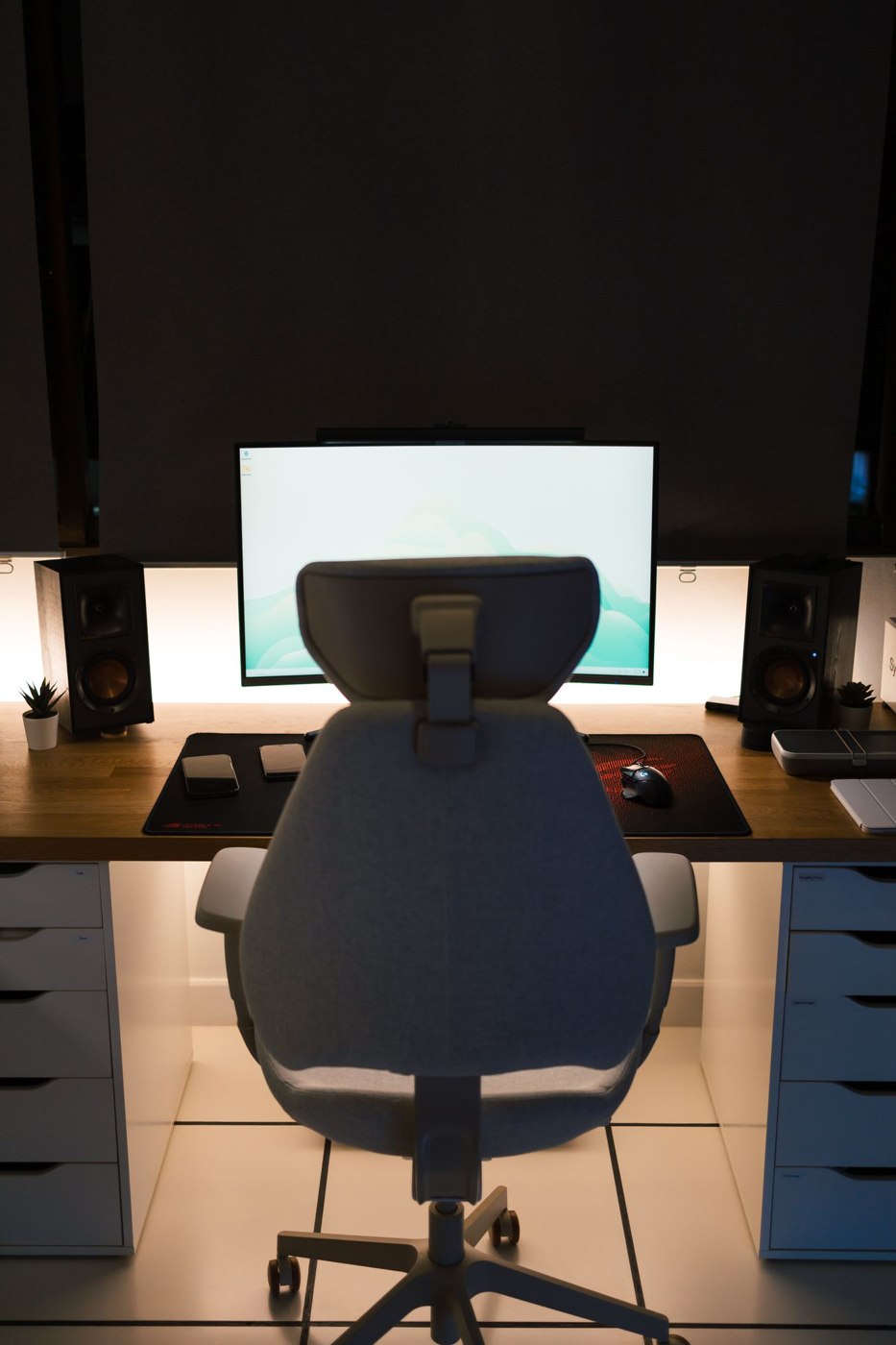 A White Office Chair Beside Desk with Computer