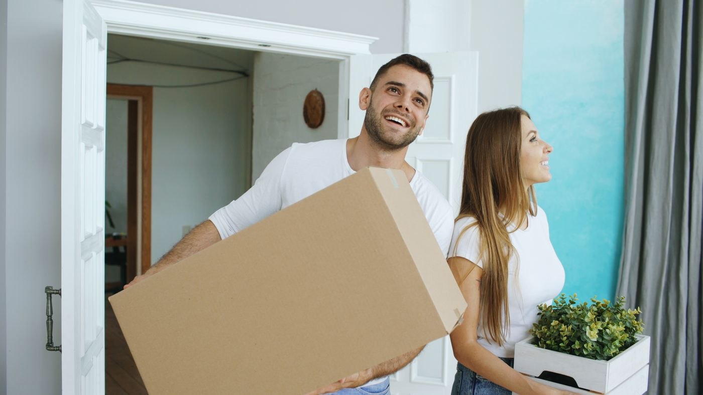 Happy Couple Moving into New Home with Boxes