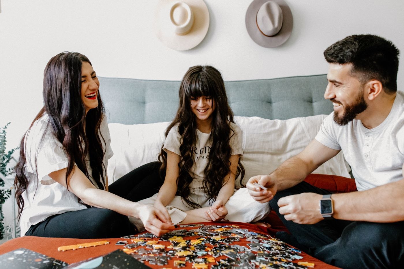 A family working on a jigsaw puzzle together