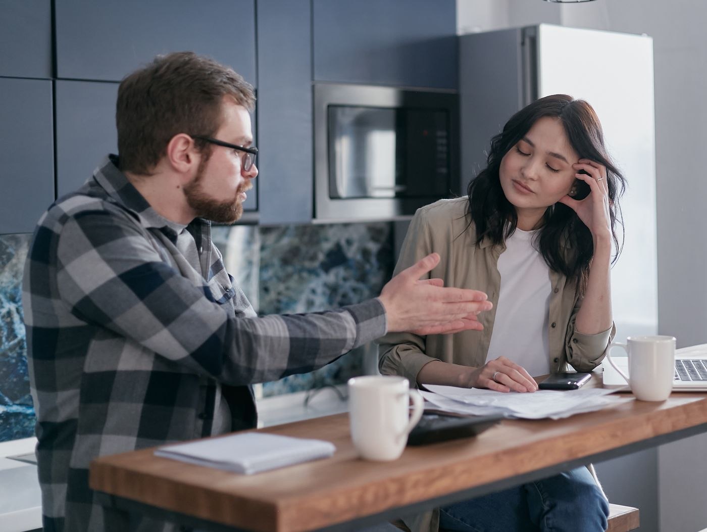 Two people talking at a kitchen counter