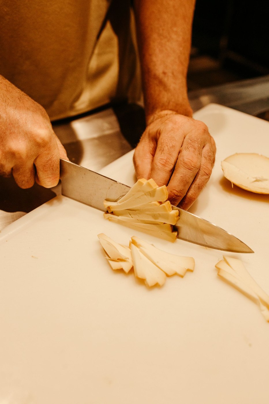 Close-Up Shot of a Person Slicing a Vegetable