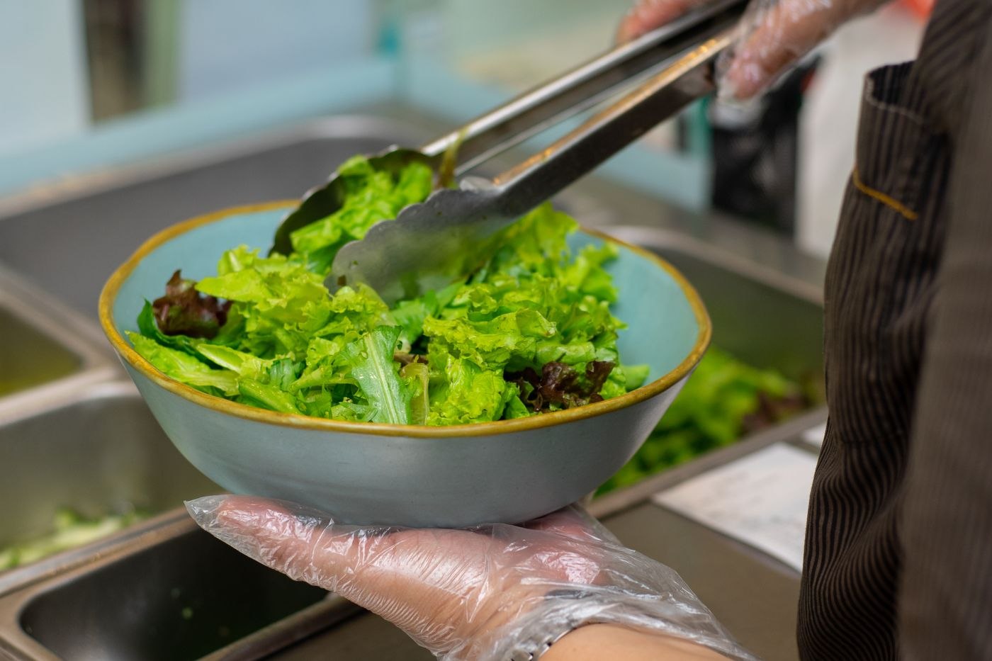 Fresh Green Salad Being Prepared in Kitchen